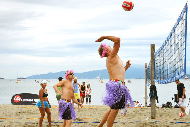 Photo of KitsFest, a volleyball player hitting a ball in a Hawaiian skirt