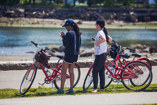 Photo of visitors biking along the Stanley Park Seawall