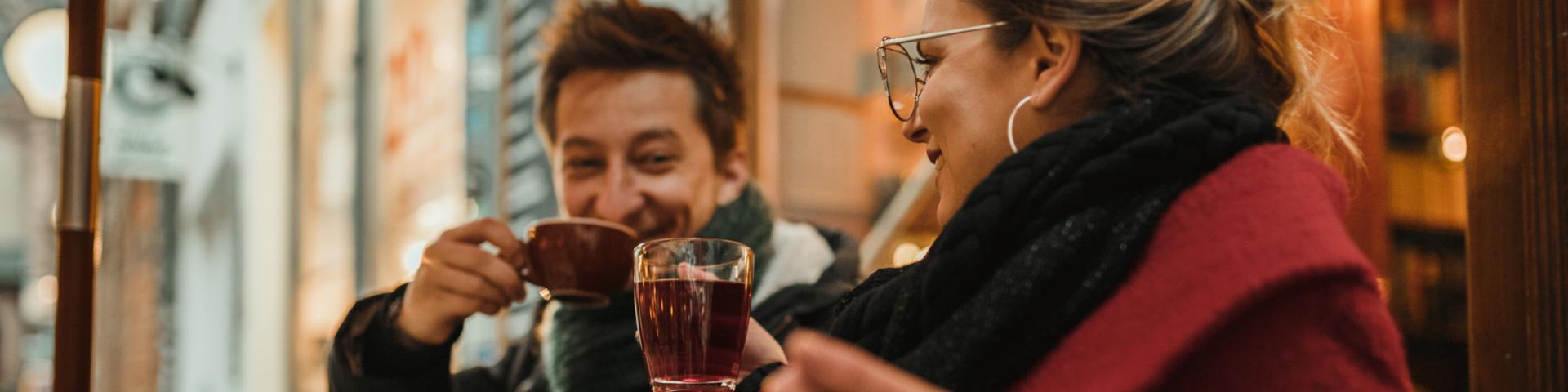 Two people enjoying a cozy cup of tea and coffee