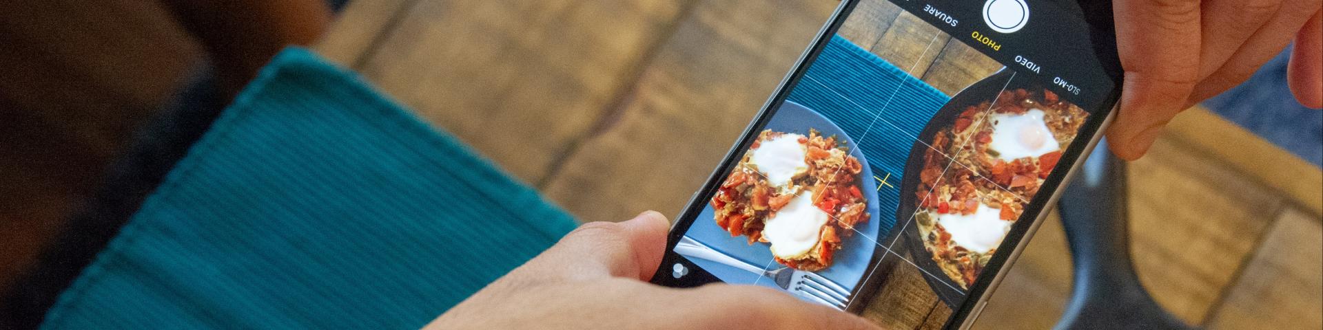 Photo of person taking picture of food