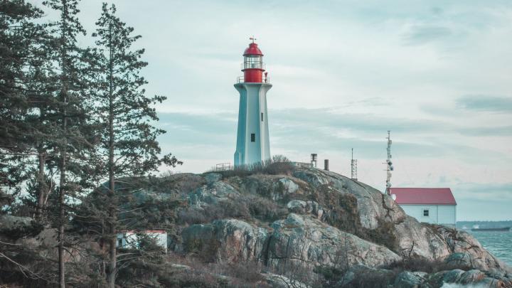 Beautiful lighthouse at Lighthouse park along the shore 