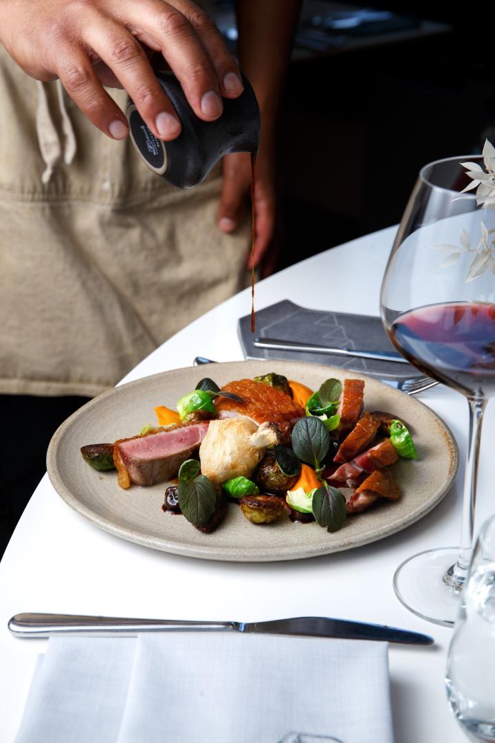 Photo of a chef prepping a dish at botanist