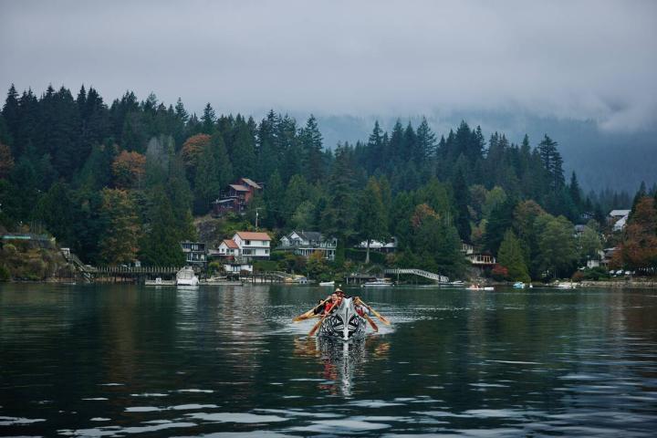 A family enjoying a guided canoe experience with Takaya Tours at Deep Cove