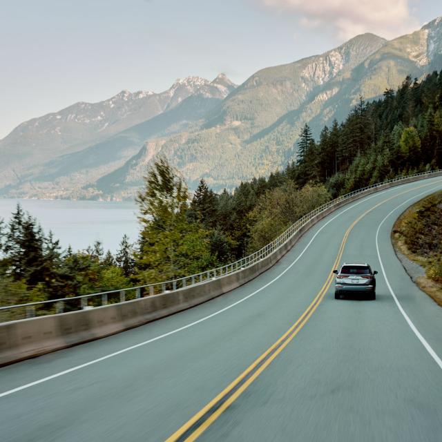 A photo of a car driving up the Sea to Sky Highway in British Columbia